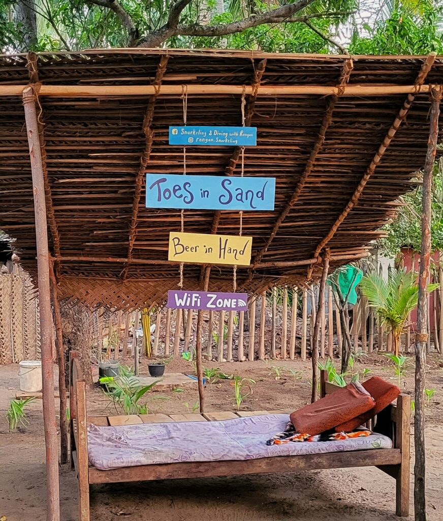 Bambus-Bett im Garten in Sri Lanka mit bunten Schildern